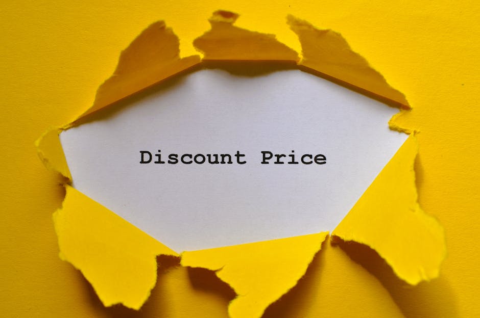 A close-up of a torn yellow paper with jagged edges reveals a white inner layer with the words 'Discount Price' typed in black, typewriter-style font. The torn paper appears to be part of a promotional or advertising material, and the background is also yellow, matching the torn exterior. The texture of the paper is slightly rough, with visible fibers along the torn edges, and the lighting is even, highlighting the contrast between the bright yellow exterior and the plain white interior. This image could relate to promotional offers, discounts, or special pricing in contexts such as retail, marketing, or services, including waste management or rubbish removal, where special deals or reductions might be advertised. The overall composition maintains a professional, neutral tone, focusing on the visual contrast and message of a discounted price, aligning naturally with themes of affordability and value in commercial waste disposal or independent collection services provided by companies like Rubbish Clearance Balham.